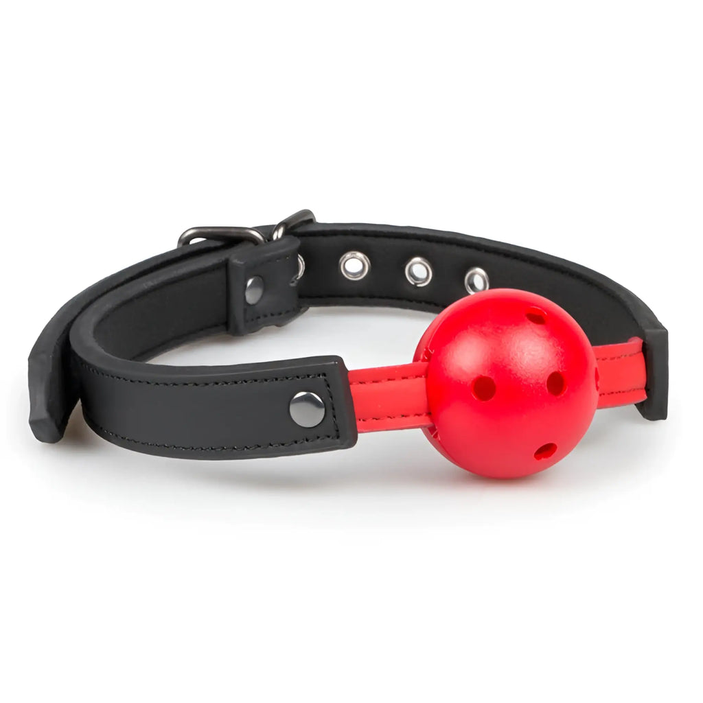Red plastic ball gag with black leather strap and metal hardware from fetish collection for pvc ball red use
