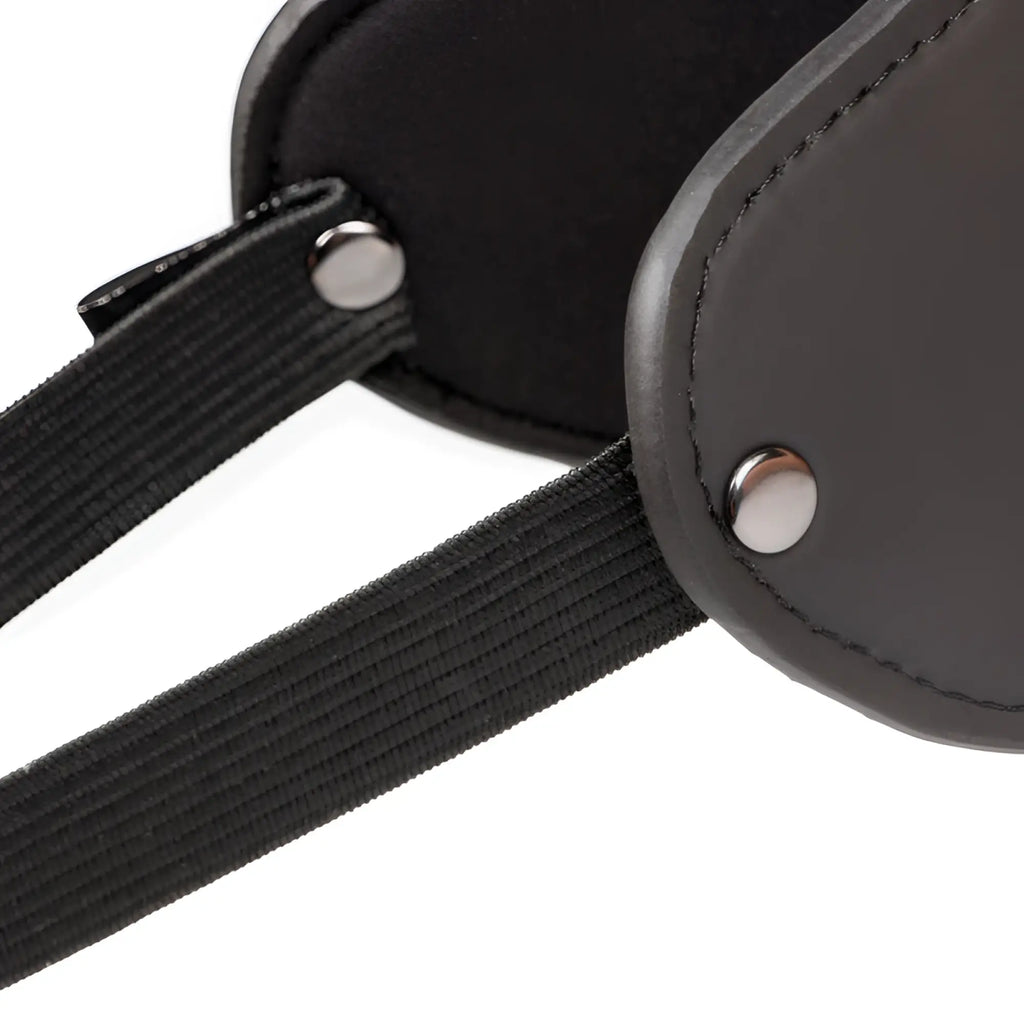 Black leather eye mask with elastic straps and silver metal rivets from the fetish collection beginners bondage fantasy kit
