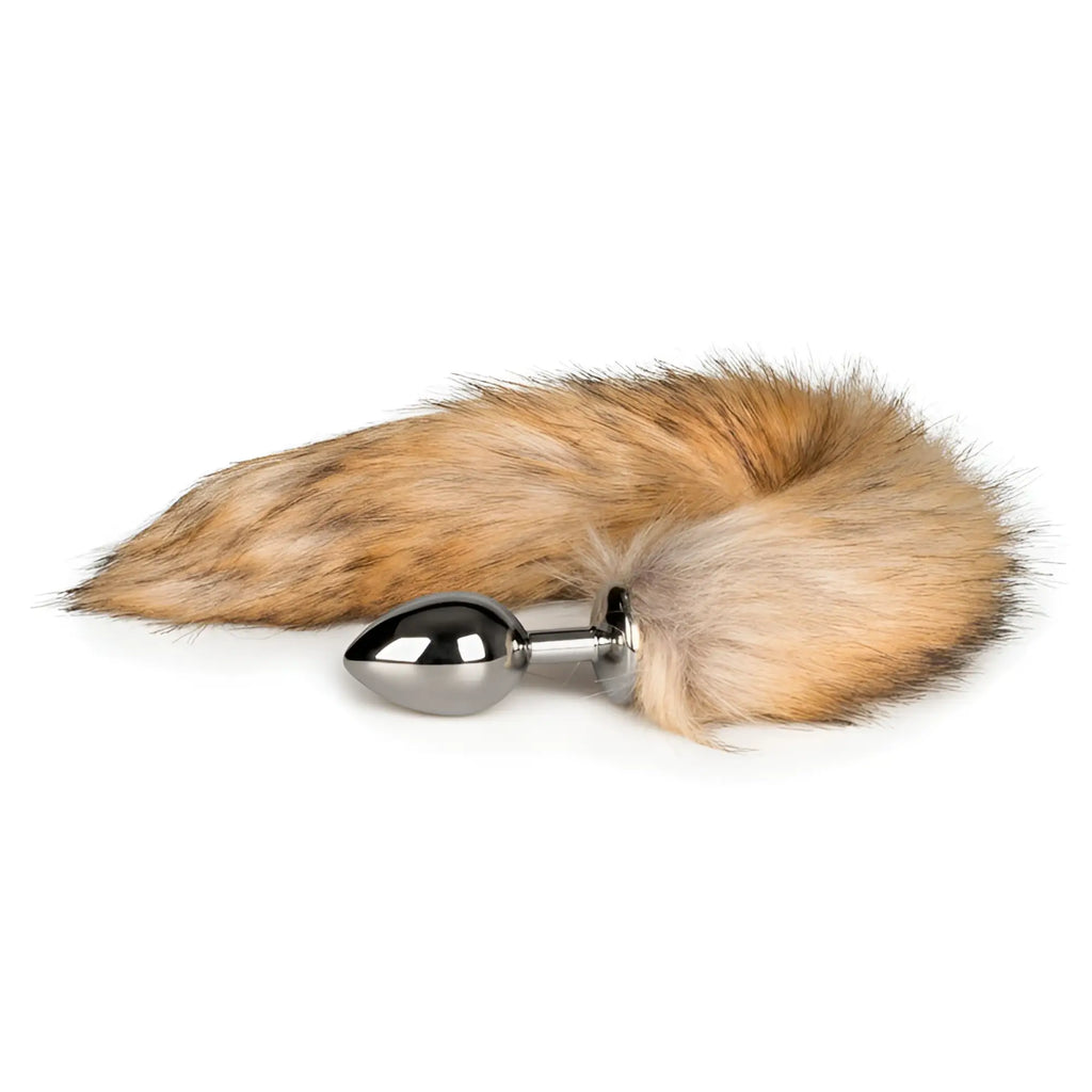 A sleek silver metallic anal plug with a natural brown and tan plush fox tail attachment from Fetish Collection
