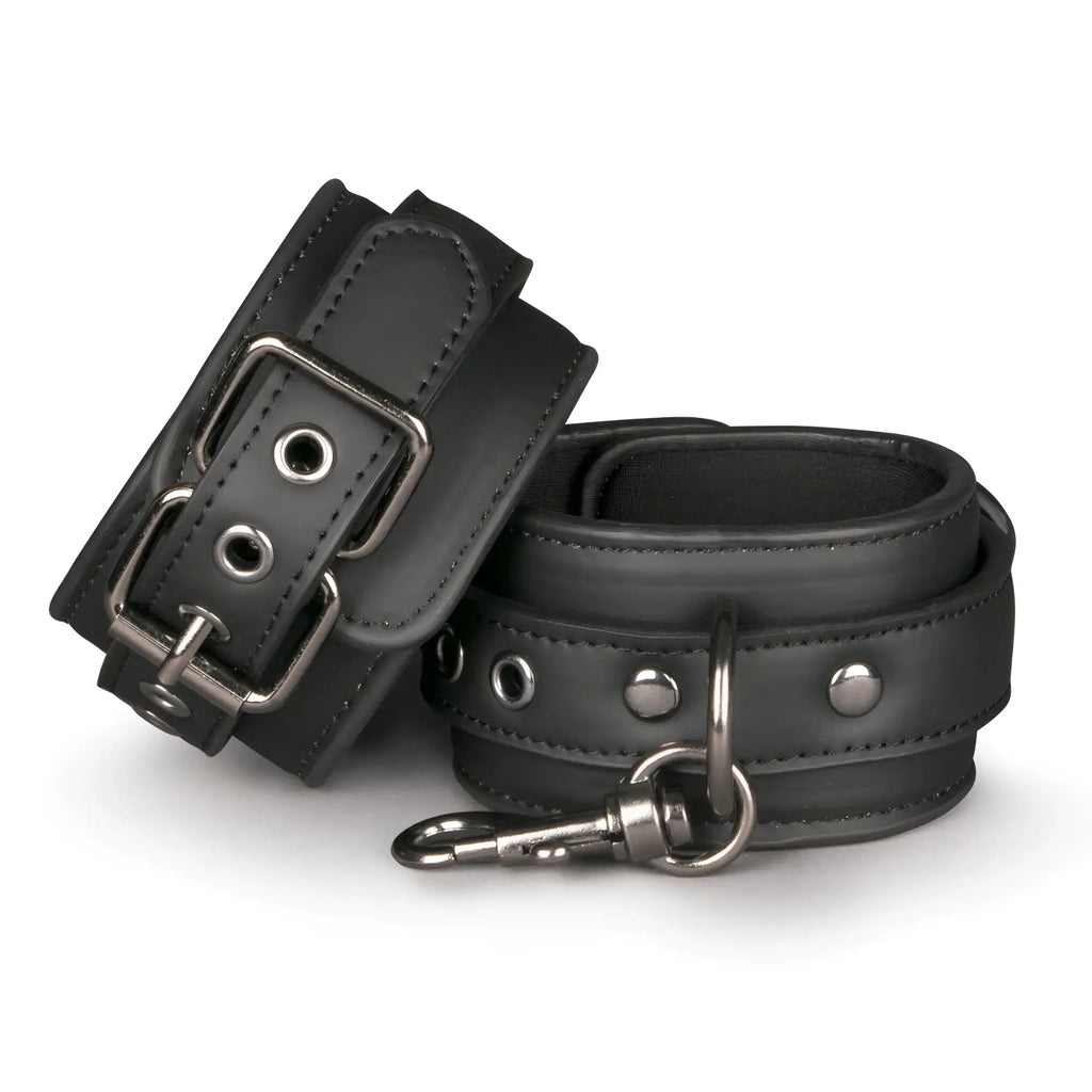 Black leather wrist cuffs from the fetish collection with silver metal buckles and a detachable snap hook
