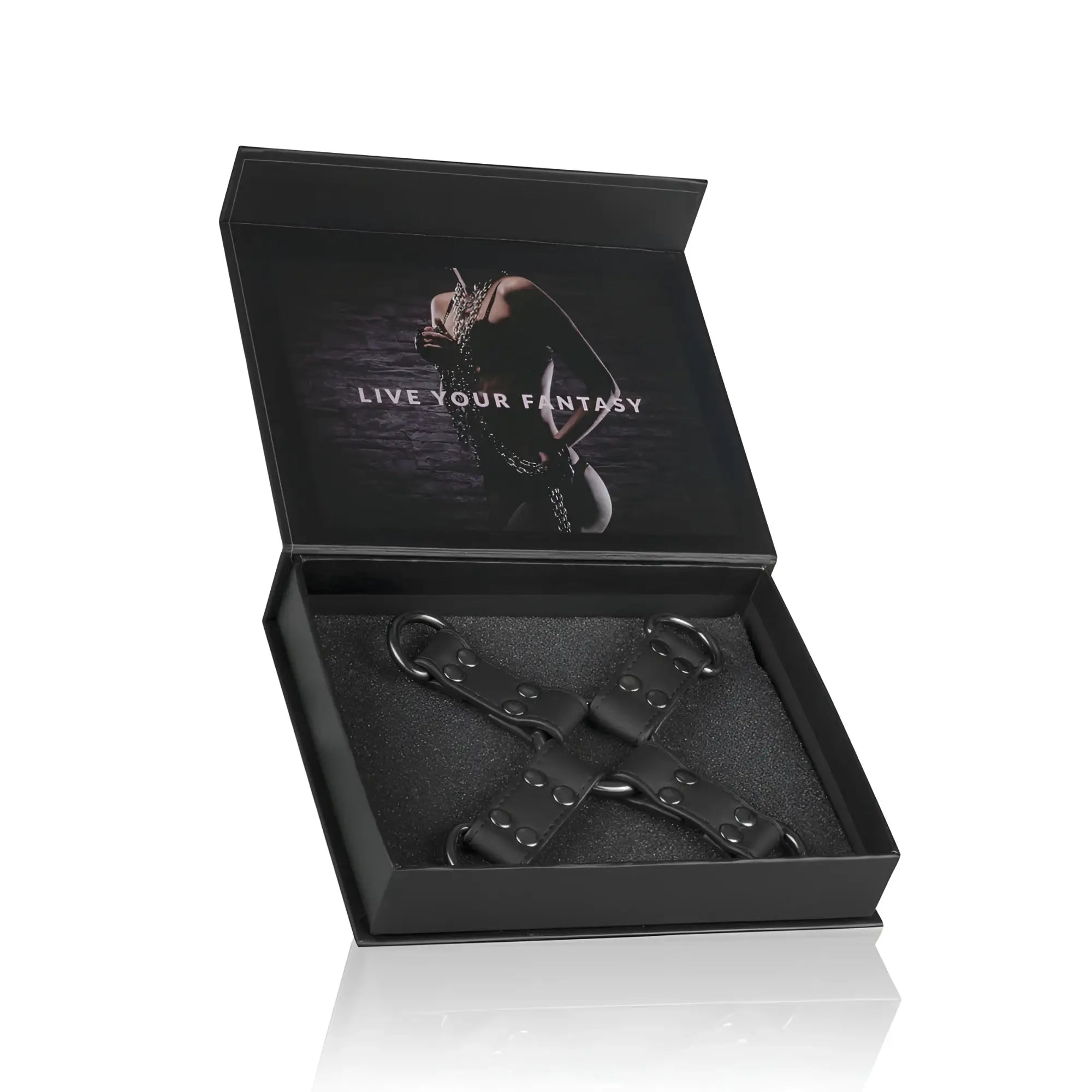 Black leather x-shaped restraint harness with metal d-rings and rivets in a sleek black gift box from Fetish Collection Hogtie Black