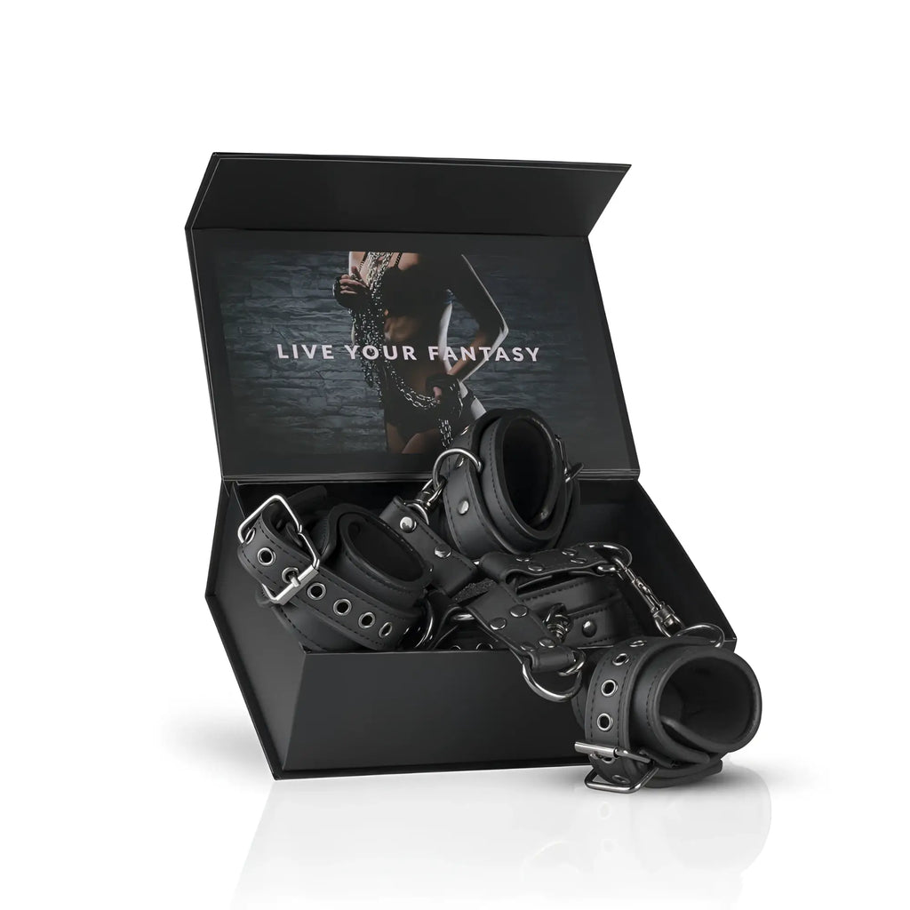 Black leather hogtie bondage set with hand and ankle cuffs featuring silver toned metal hardware
