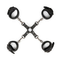 Black leather handcuffs with silver metal chains arranged in a cross for fetish collection hogtie use