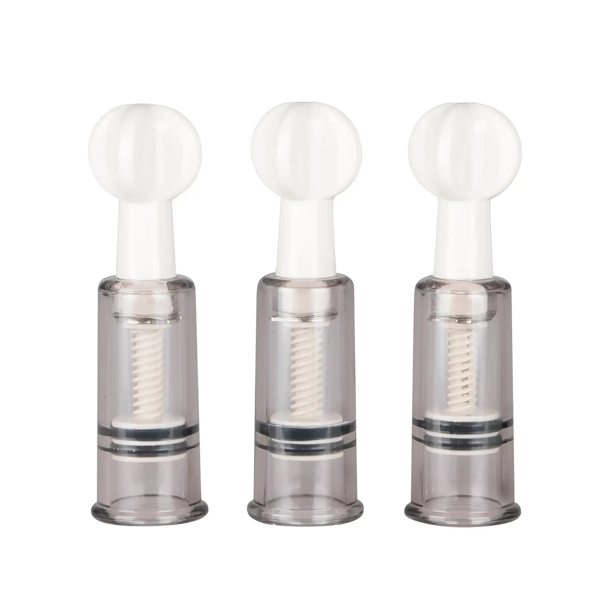 Three transparent plastic fetish collection nipple and clit suckers with white spherical tops and internal springs