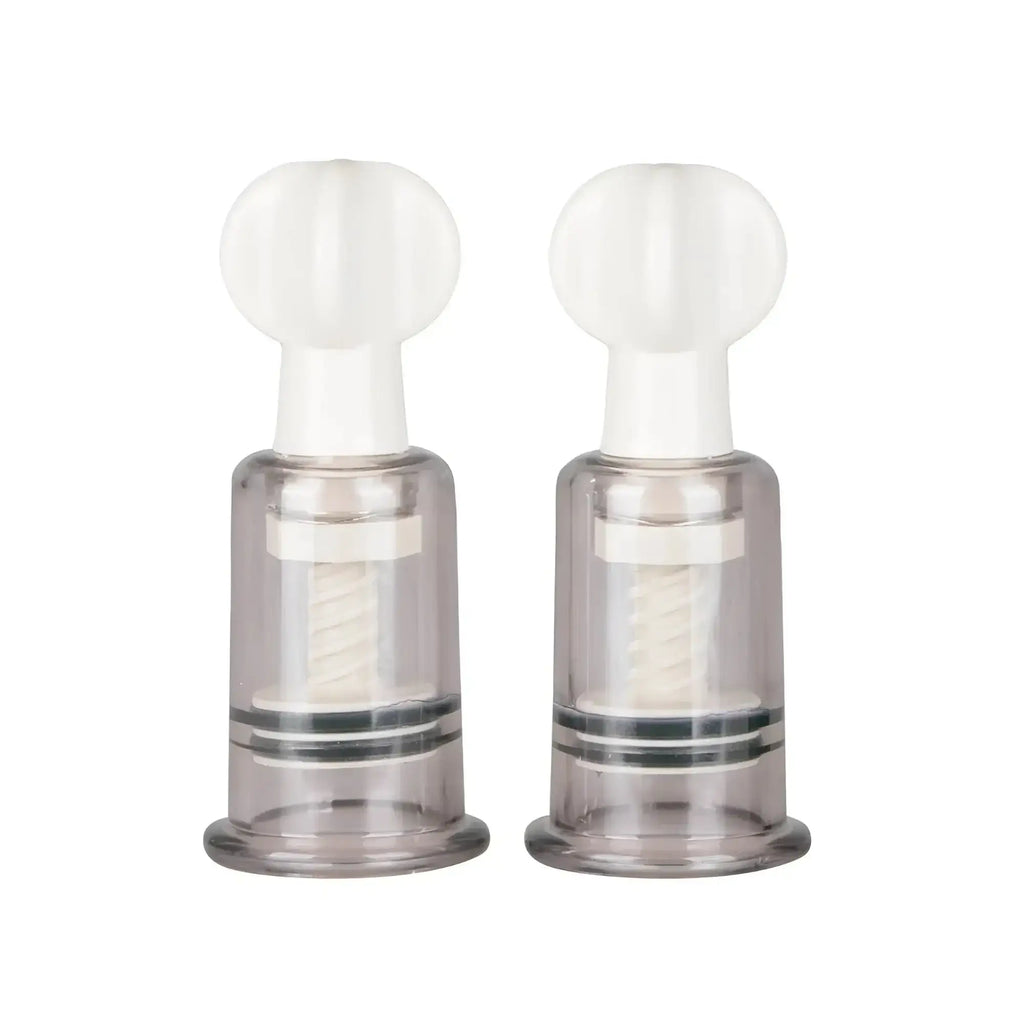 Transparent plastic fetish collection medium nipple and clit suckers with white tops and internal spiral mechanisms