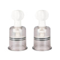 Transparent plastic breast pumps with white silicone tops and silver metallic rings from fetish collection medium 2 pc set