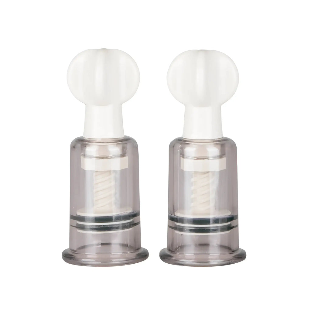 Transparent plastic fetish collection medium nipple and clit suckers with white tops and internal spiral mechanisms