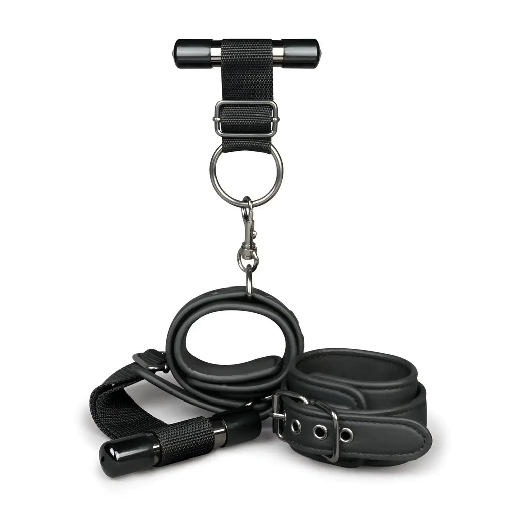 Black leather bondage set with metal hardware and t-bar harness from fetish collection over the door wrist cuffs
