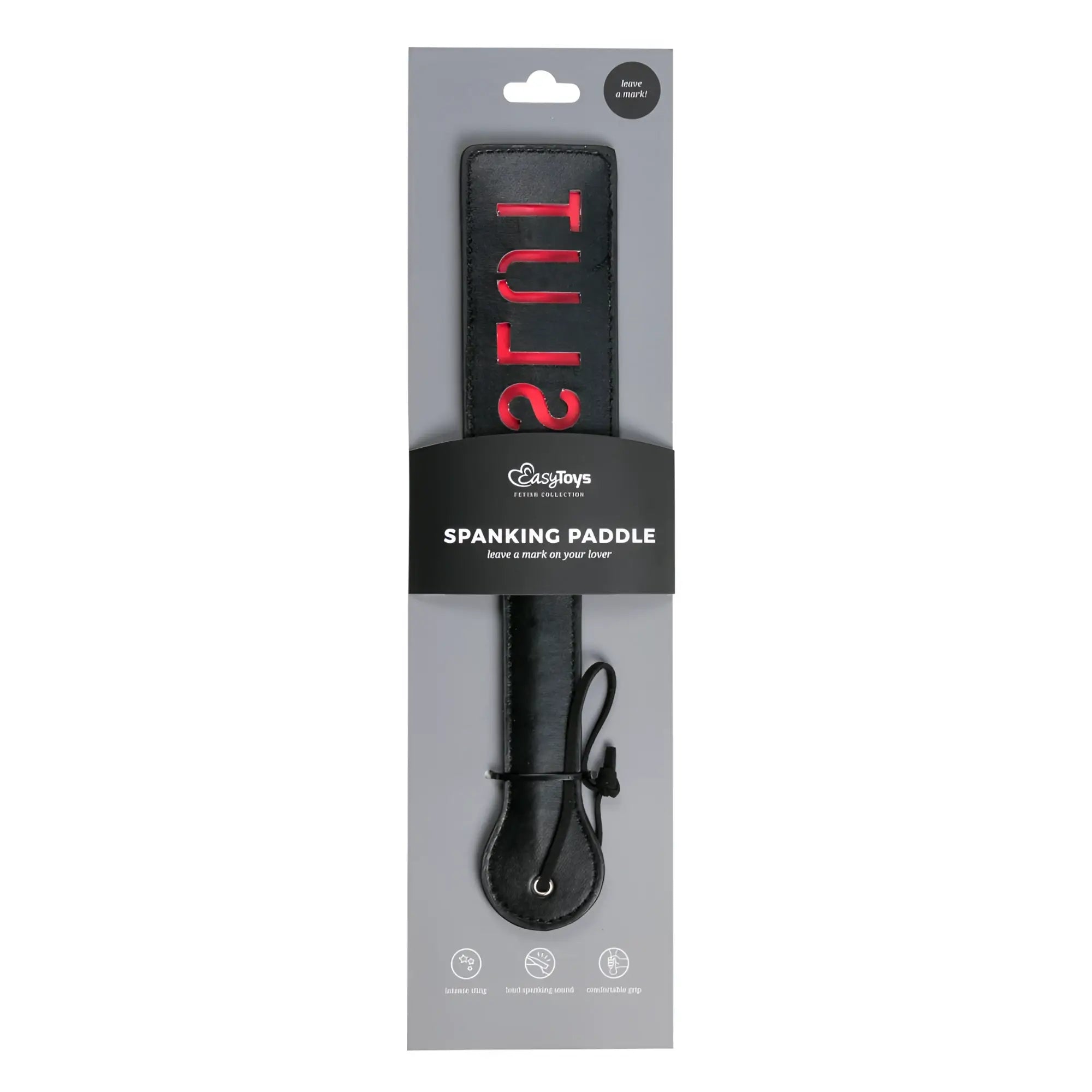 Black leather spanking paddle with red slut lettering on handle packaged in branded cardboard sleeve from fetish collection