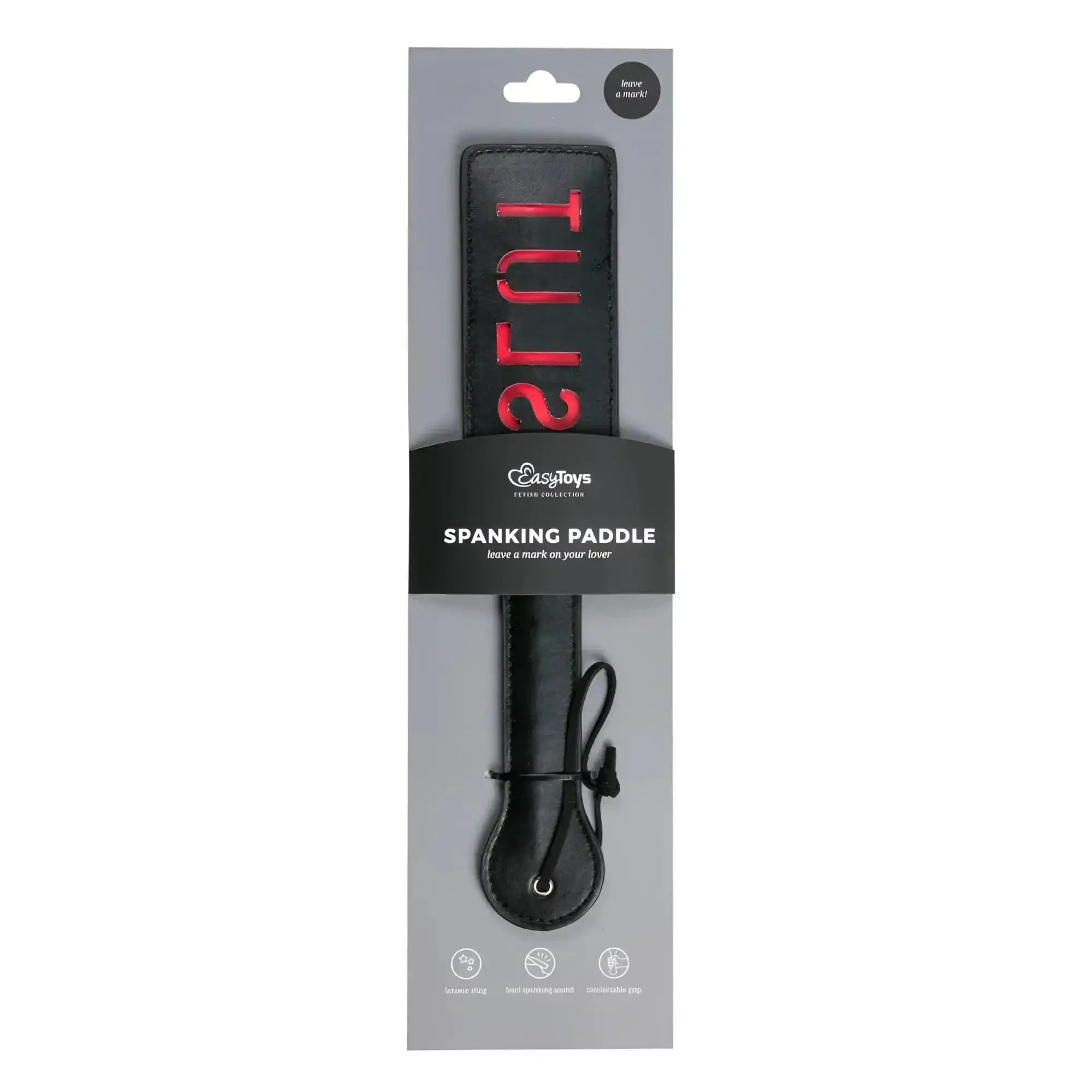 Black leather spanking paddle with red slut lettering on handle packaged in branded cardboard sleeve from fetish collection
