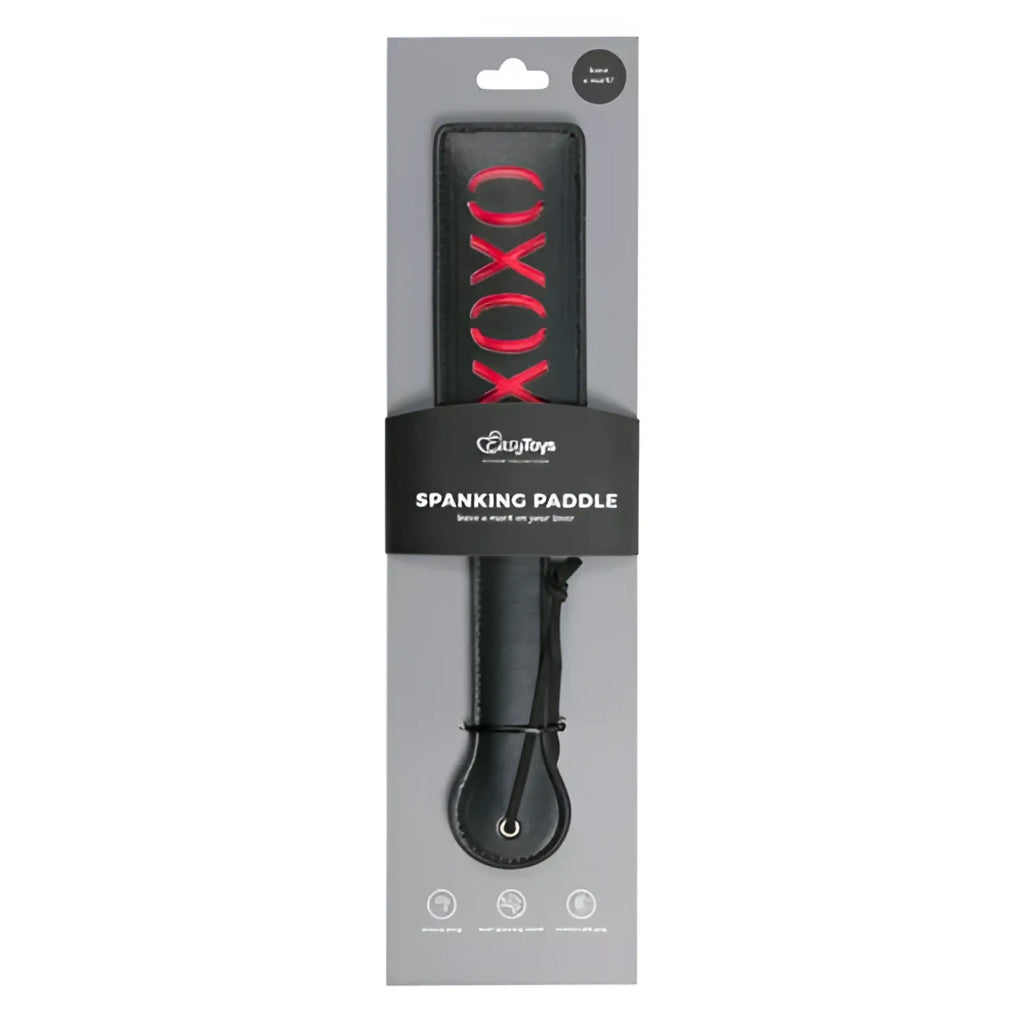 Black leather fetish collection paddle with red xoxo lettering on the handle for spanking
