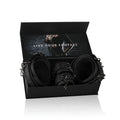 Black leather thigh and wrist cuff set with metal hardware in a sleek black box from fetish collection