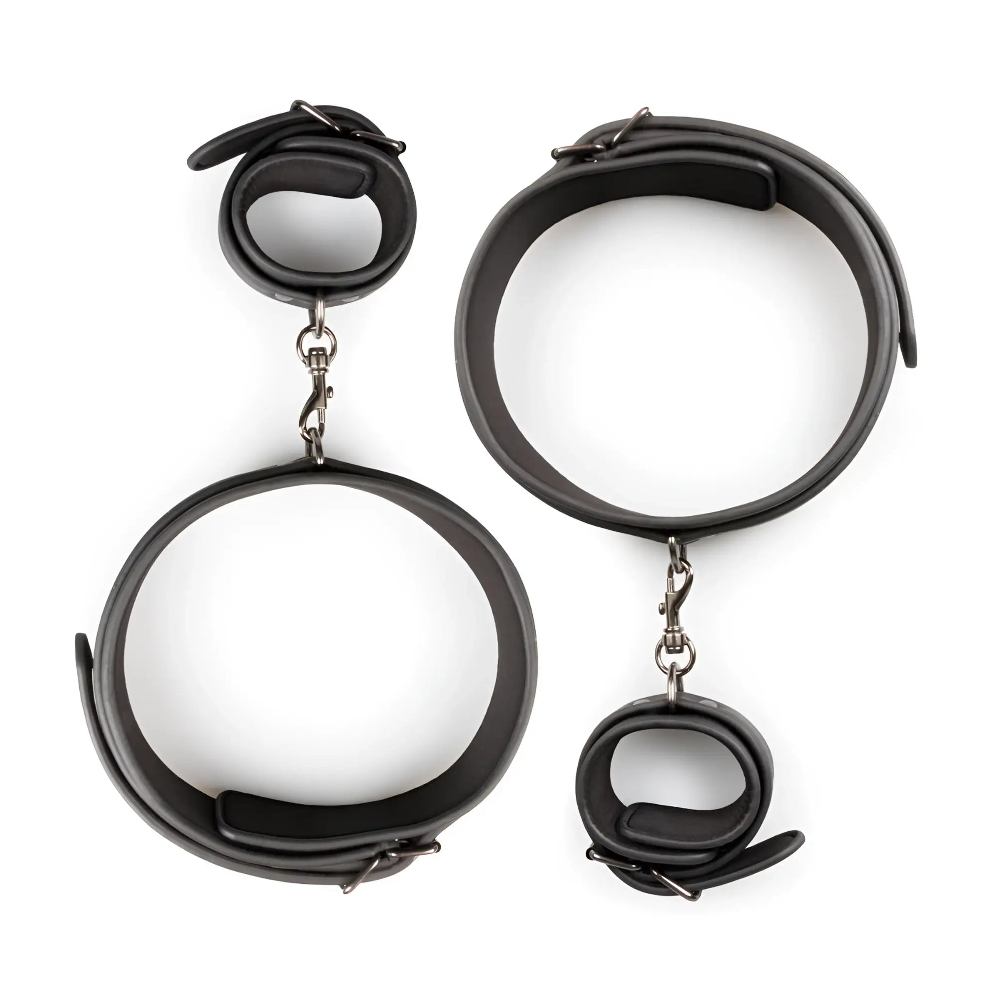 Fetish collection thigh and wrist cuff set featuring black leather handcuffs with silver-toned metal clasps and adjustable straps