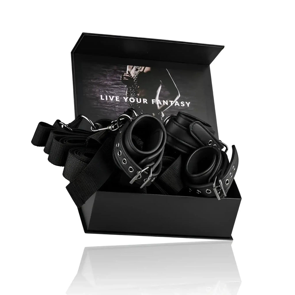 Black leather bondage set with metal hardware and adjustable straps from fetish collection under mattress restraint set