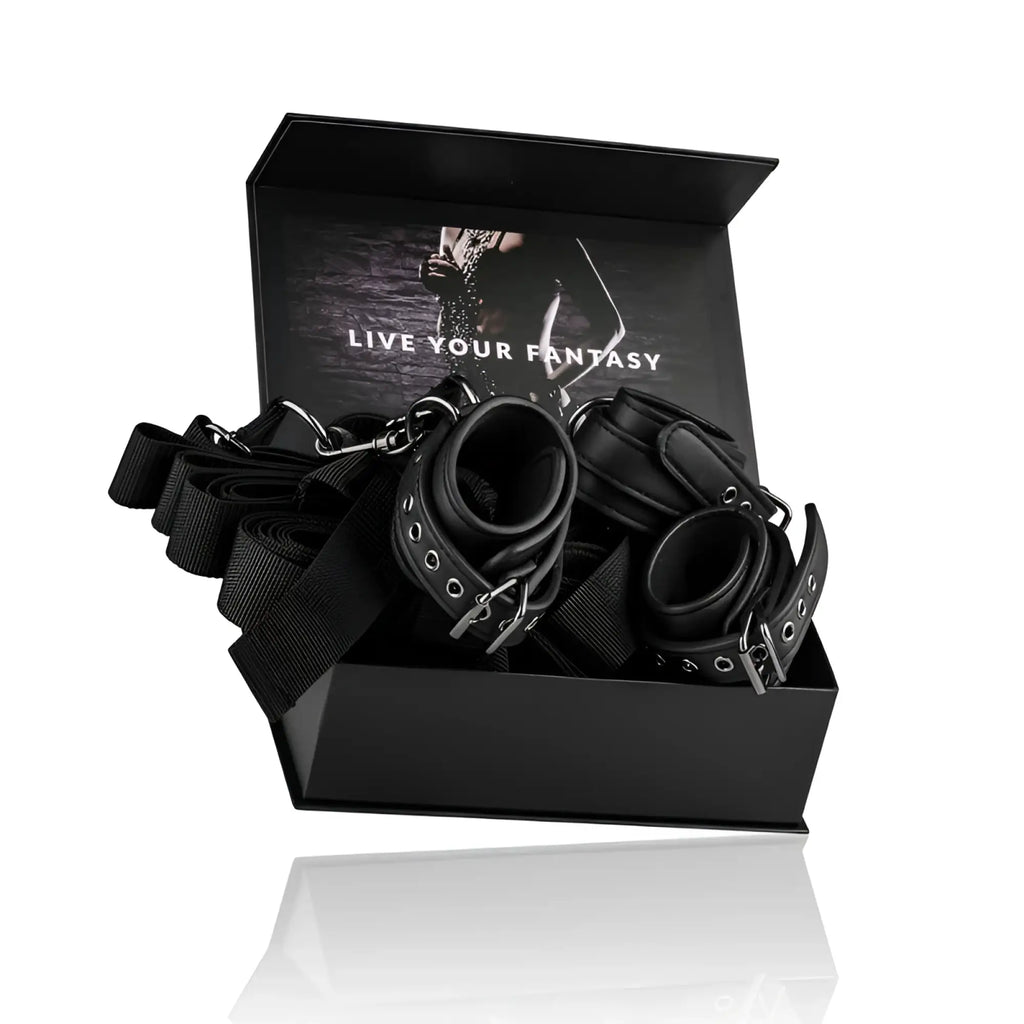 Black leather bondage set with metal hardware and adjustable straps from fetish collection under mattress restraint set