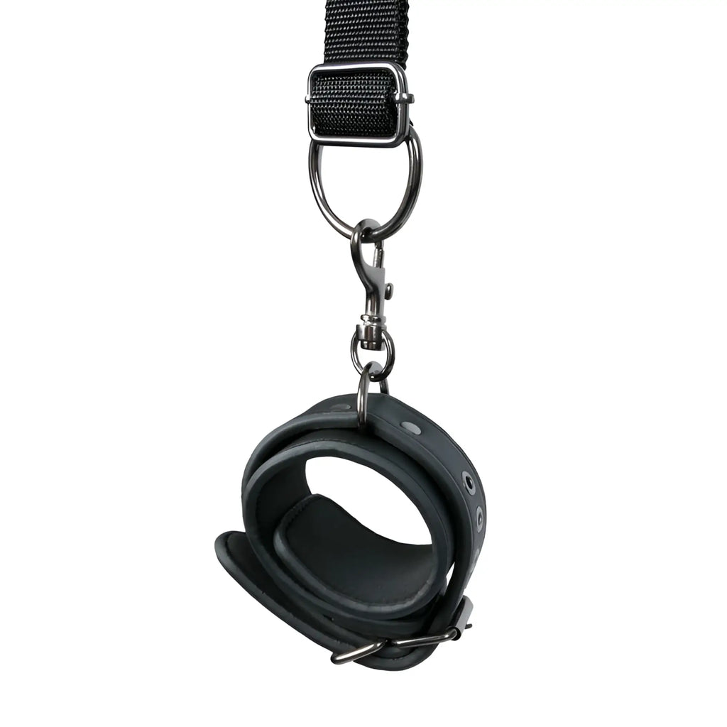 Black leather wrist cuff with metal hardware and adjustable strap from fetish collection under mattress restraint set