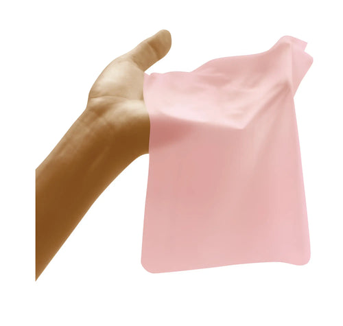 A soft translucent pink silicone cleaning pad held in hand from four seasons oral sheer dam 3 pc mixed flavours set