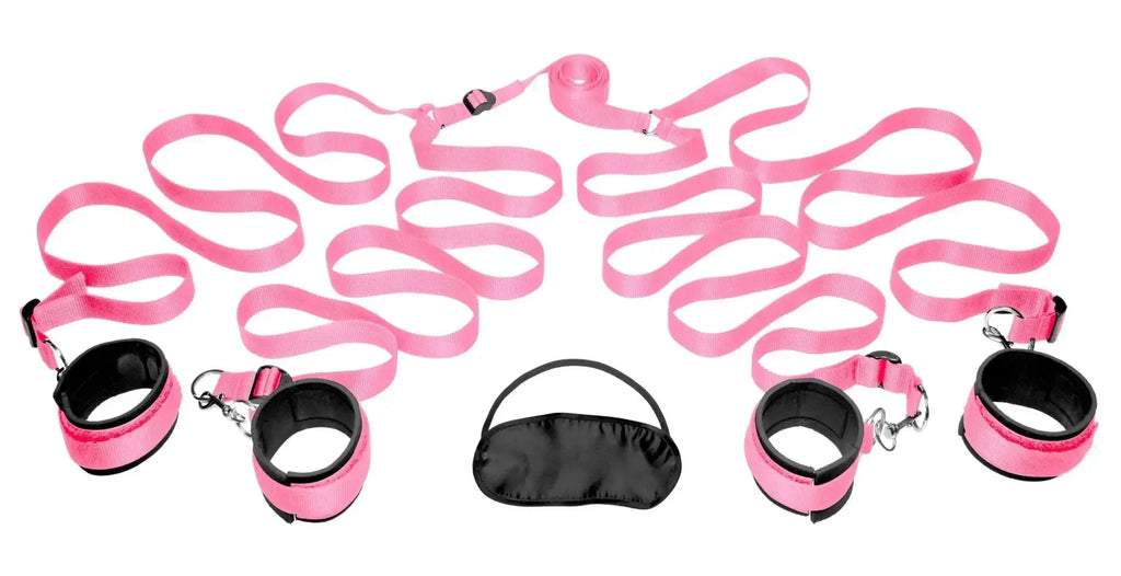 Pink satin bondage kit with black accents and metal hardware for frisky bedroom restraint play