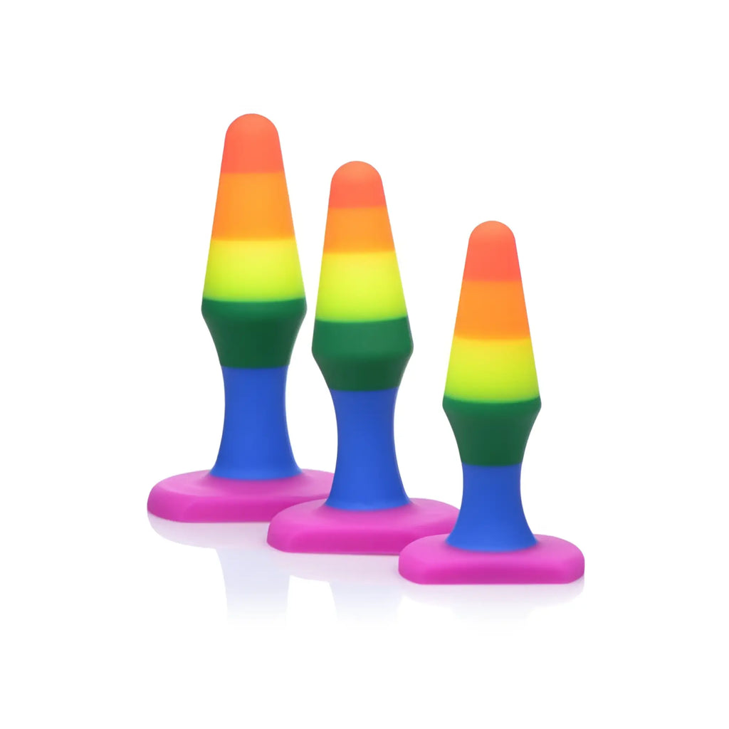 Set of three rainbow-colored silicone butt plugs with pink bases from the frisky rainbow ready anal trainer set