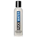 A sleek transparent bottle of fuckwater hybrid cream lubricant with black cap and blue-black label.