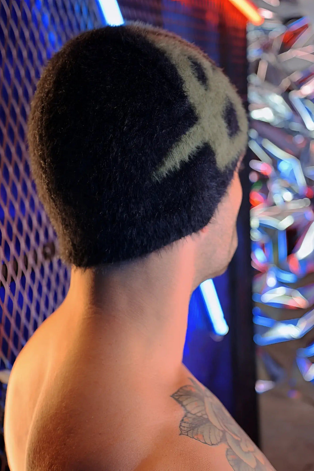 Black knit fuzz daddy beanie featuring a green skull design perfect for cold weather wear