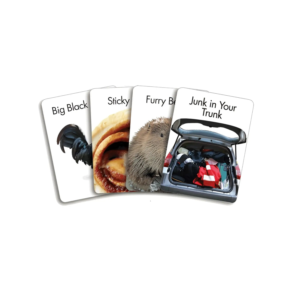 Set of four white playing cards from genie screw u card game featuring humorous images and text including a black rooster sticky cinnamon roll and hedgehog