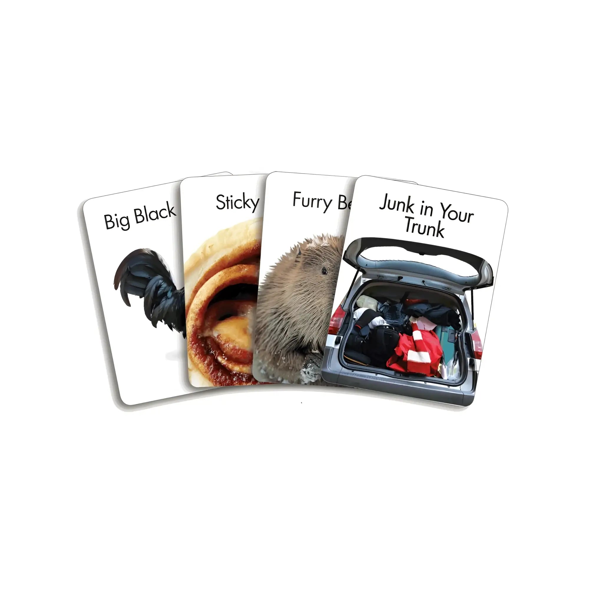Set of four white playing cards from genie screw u card game featuring humorous images and text including a black rooster sticky cinnamon roll and hedgehog