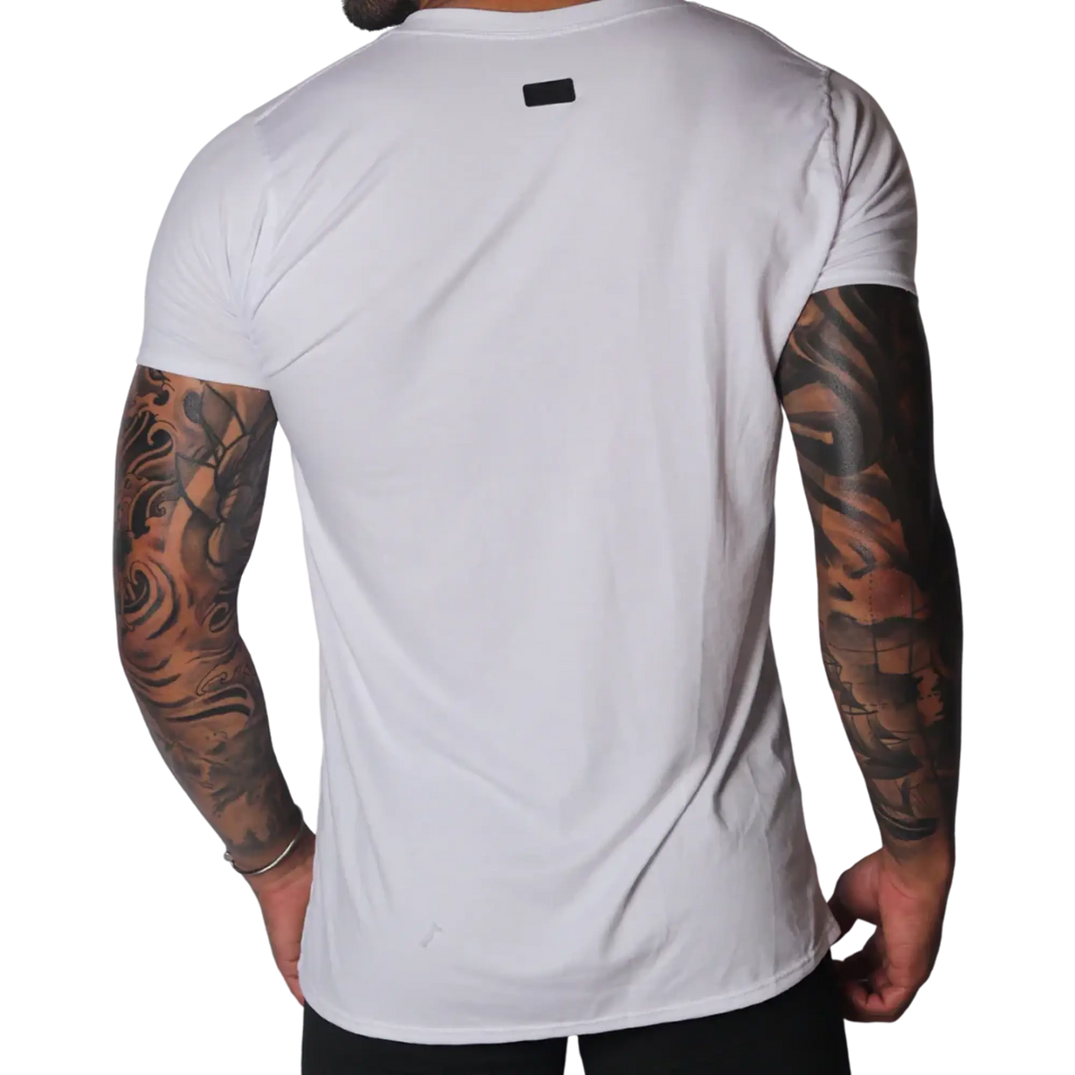 Back view of a plain white crew neck cotton T-shirt featuring a small black rectangular brand logo at the nape.