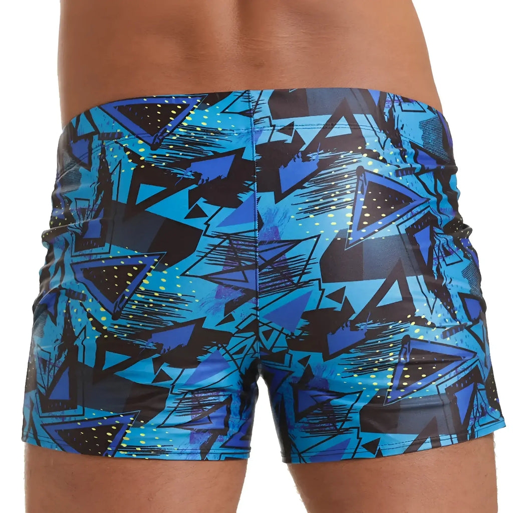 Blue and black geometric patterned swim trunks with a shiny vibrant finish from Gigo Abstract Beachwear