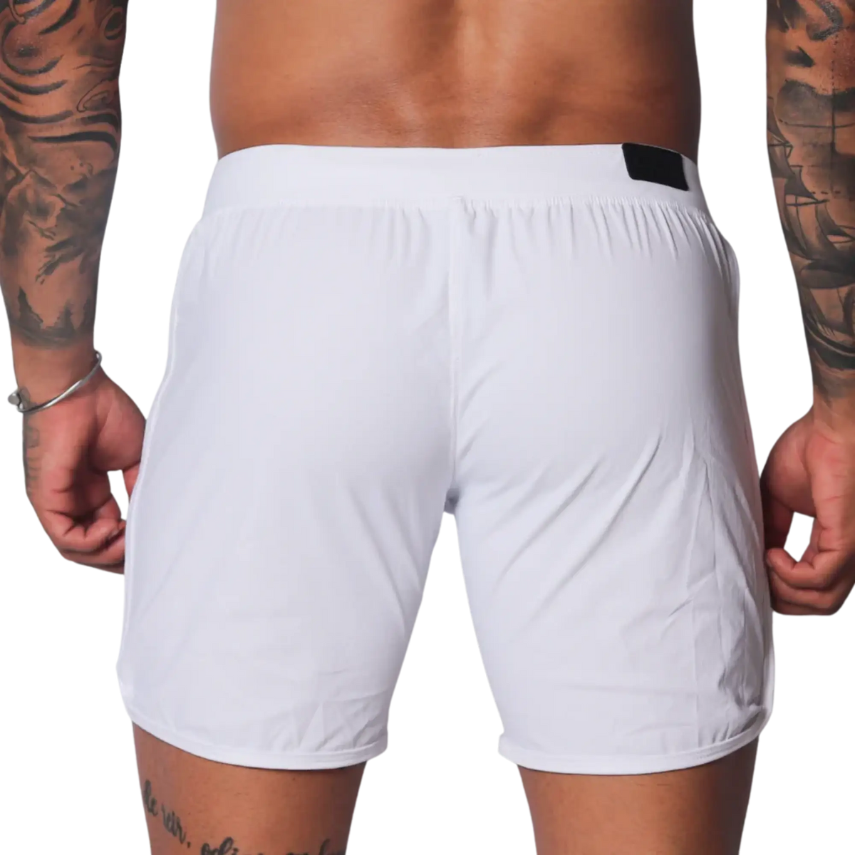 Plain white athletic shorts with a smooth, lightweight fabric, elastic waistband, and small black logo tab on the back.