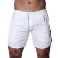 White athletic shorts featuring an elastic waistband with drawstring, side pockets, and curved hem detail.