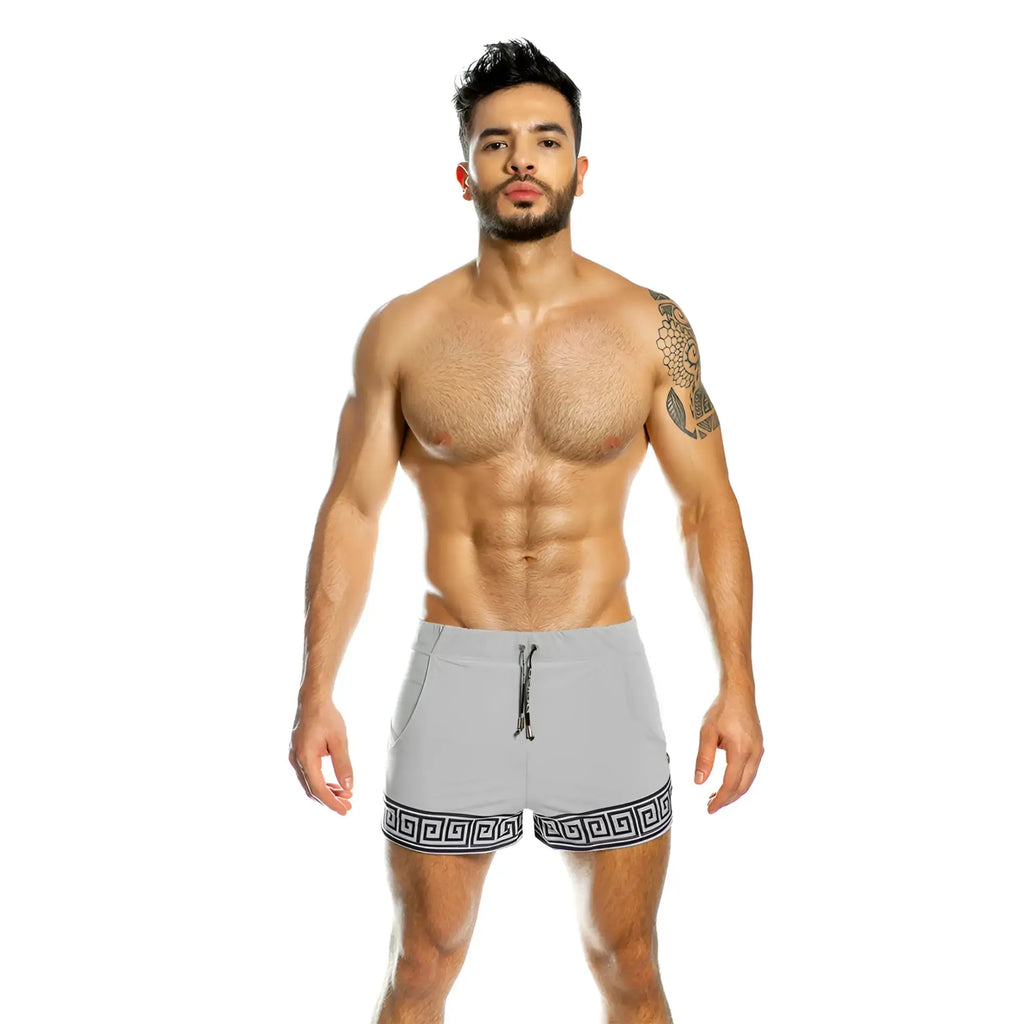 Gray athletic shorts with black greek key pattern along hem designed for beachwear by gigo arabesque