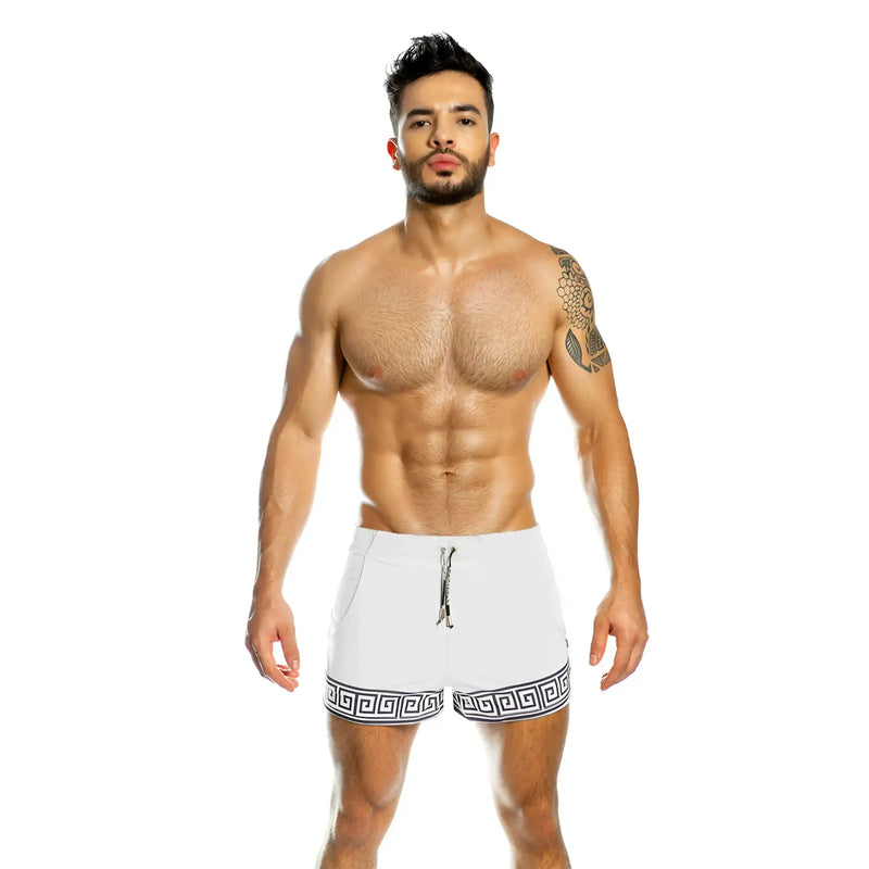 White athletic shorts with black greek key pattern hem and drawstring waistband from gigo arabesque beachwear
