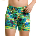 Vibrant tropical print swim trunks in neon green blue and purple with orange accents by gigo banana beachwear