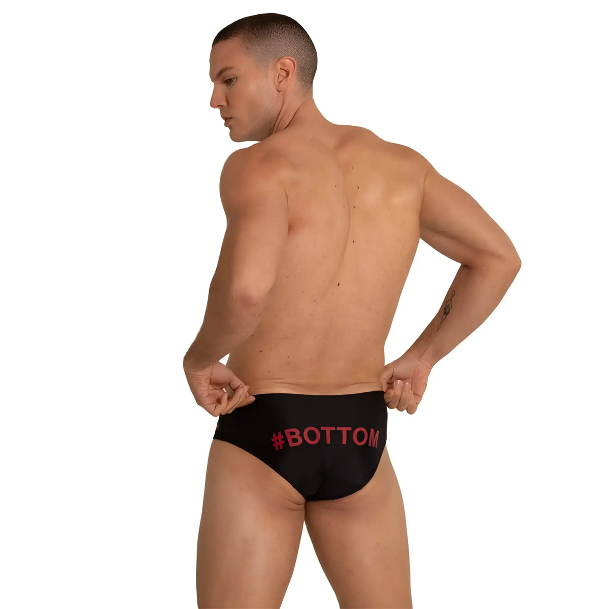 Black swim briefs with red hashtag bottom text on waistband designed for gigo bottom swimwear collection
