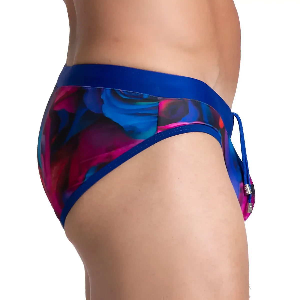 Gigo carnations swim brief featuring vibrant blue and magenta floral patterns with a solid royal blue waistband