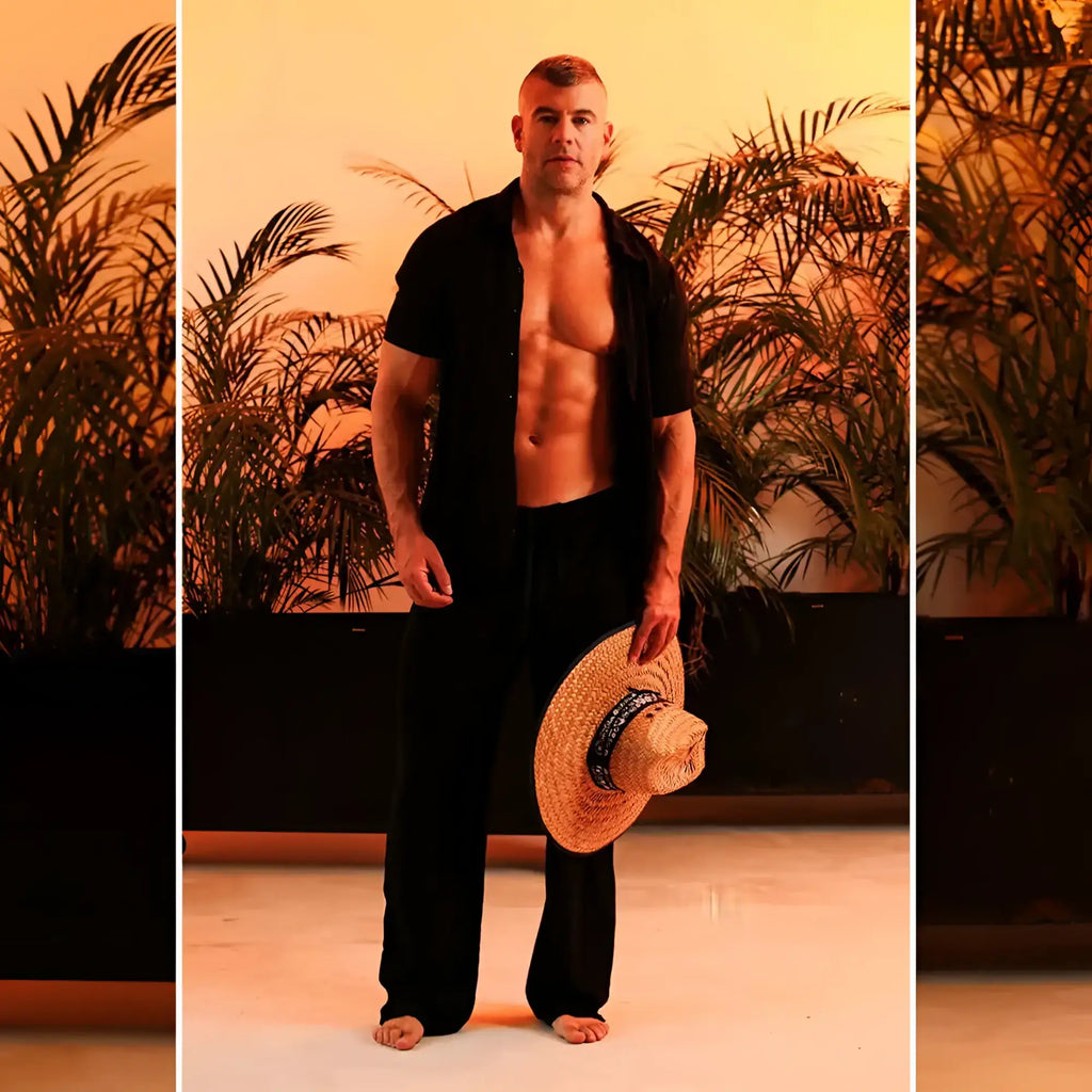 A woven straw hat with a dark blue band paired with gigo chalis black pants for a stylish summer look
