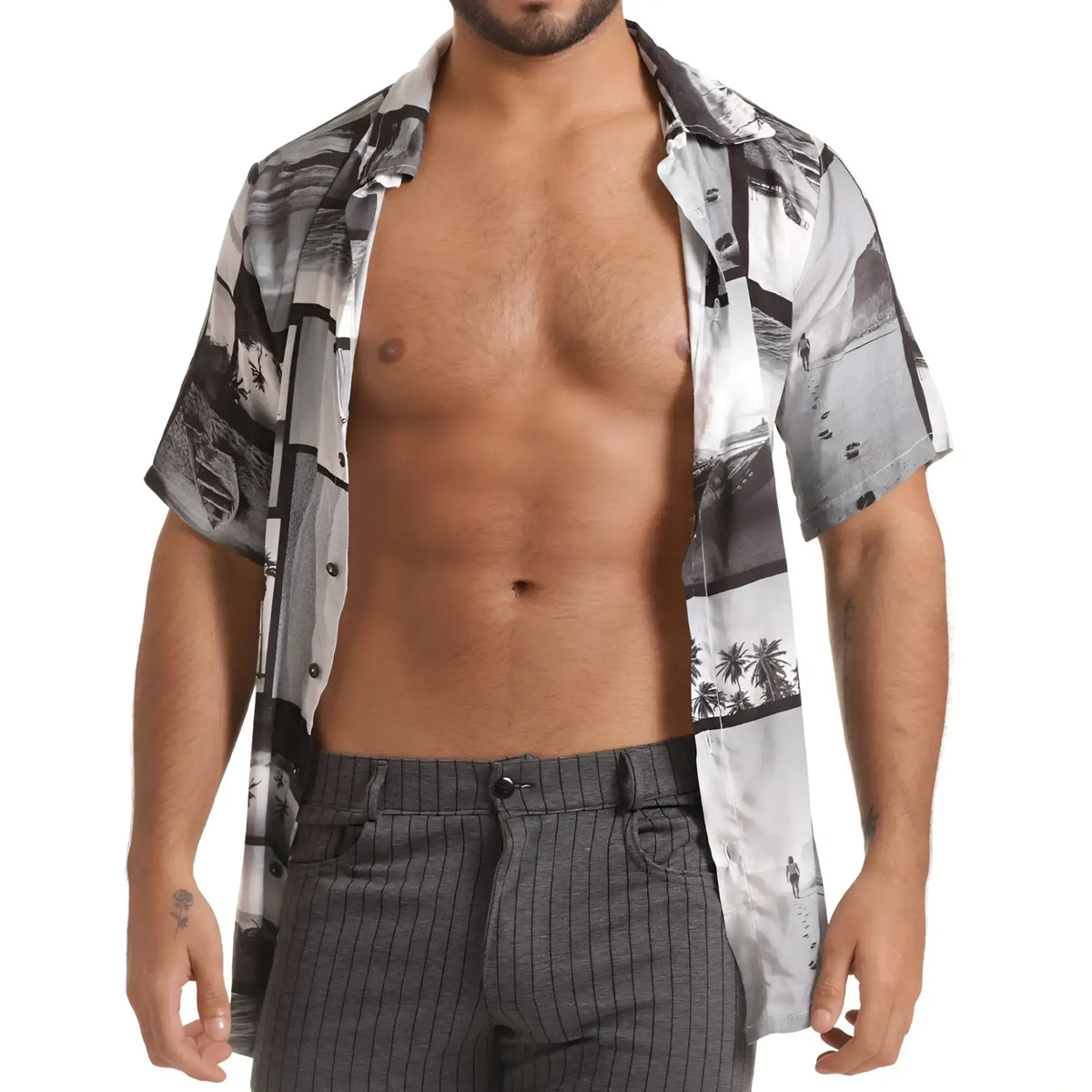 A man wearing a gigo charles shirt short-sleeved button-up with black and white coastal palm tree print