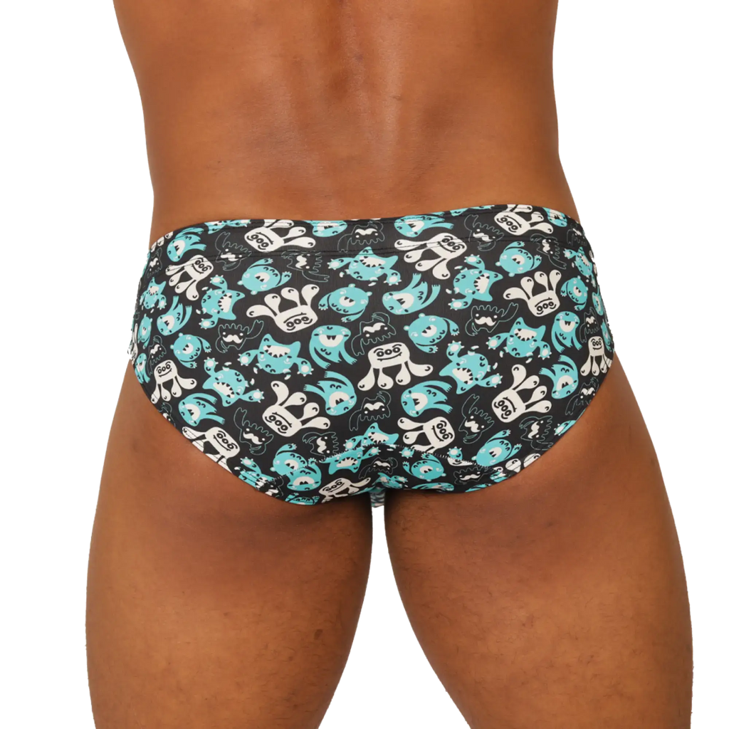 Black gigo comics swimbrief swim trunks with playful turquoise and white cartoon shark pattern for beachwear