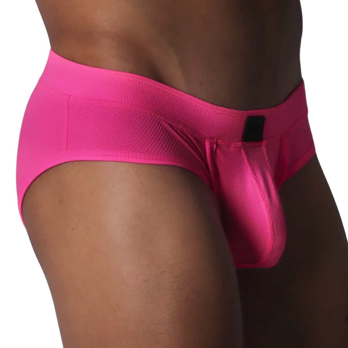 Fuchsia brief in textured, honeycomb-patterned fabric featuring a contoured pouch and a small black rectangular logo.
