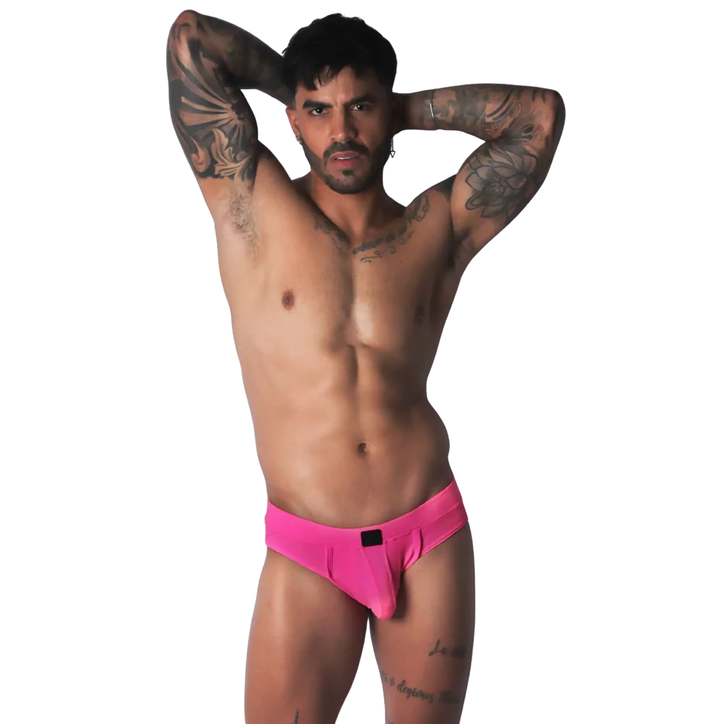 Fuchsia jockstrap brief with a smooth, matte finish and a central black logo detail on the waistband.