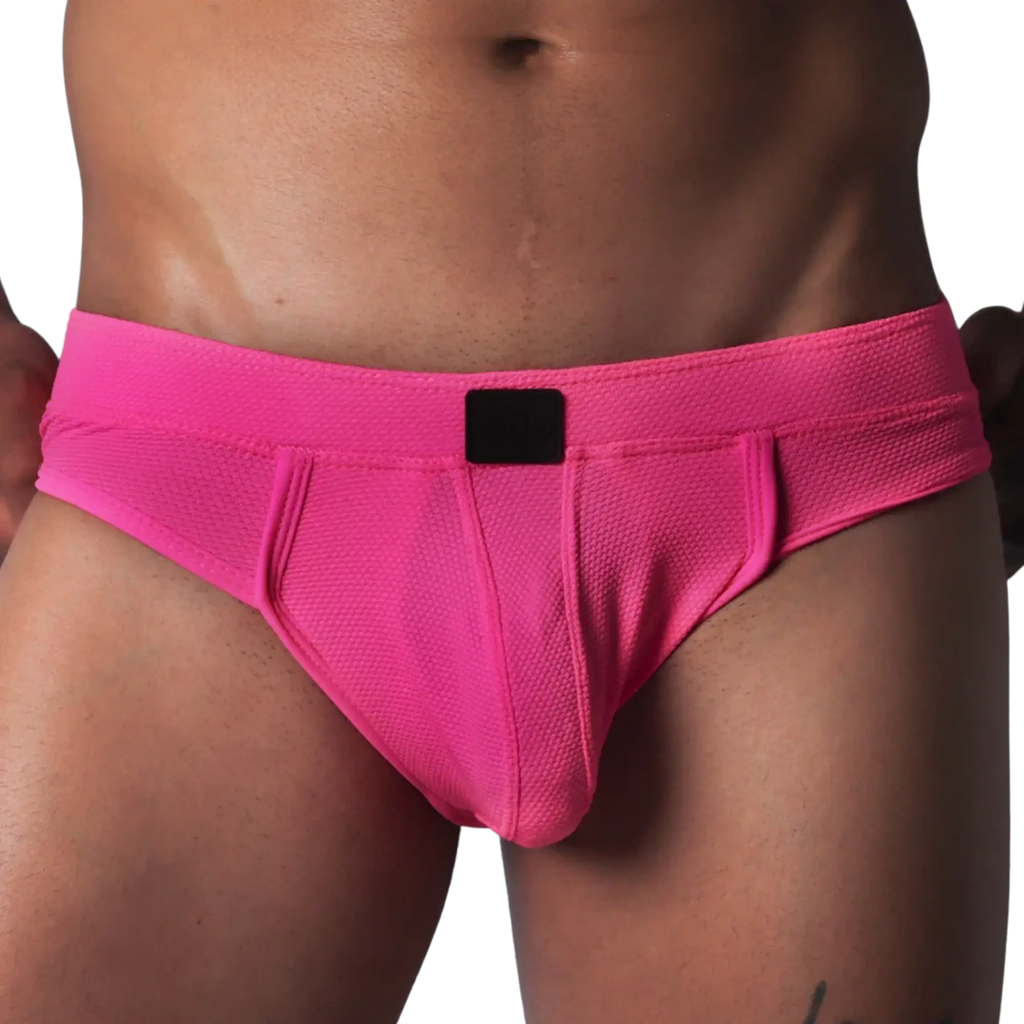 Fuchsia textured mesh jockstrap brief with a wide waistband and a central black logo patch.