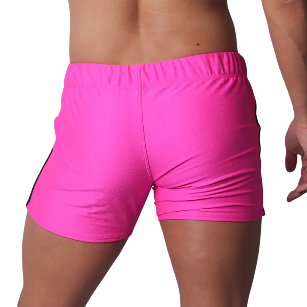 Fuchsia athletic short-shorts in a textured performance fabric with an elastic waistband, viewed from the back.