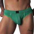 Green jockstrap featuring a textured honeycomb fabric, wide waistband, and a solid black central logo patch.
