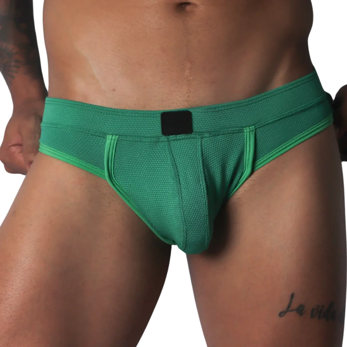 Green jockstrap featuring a textured honeycomb fabric, wide waistband, and a solid black central logo patch.