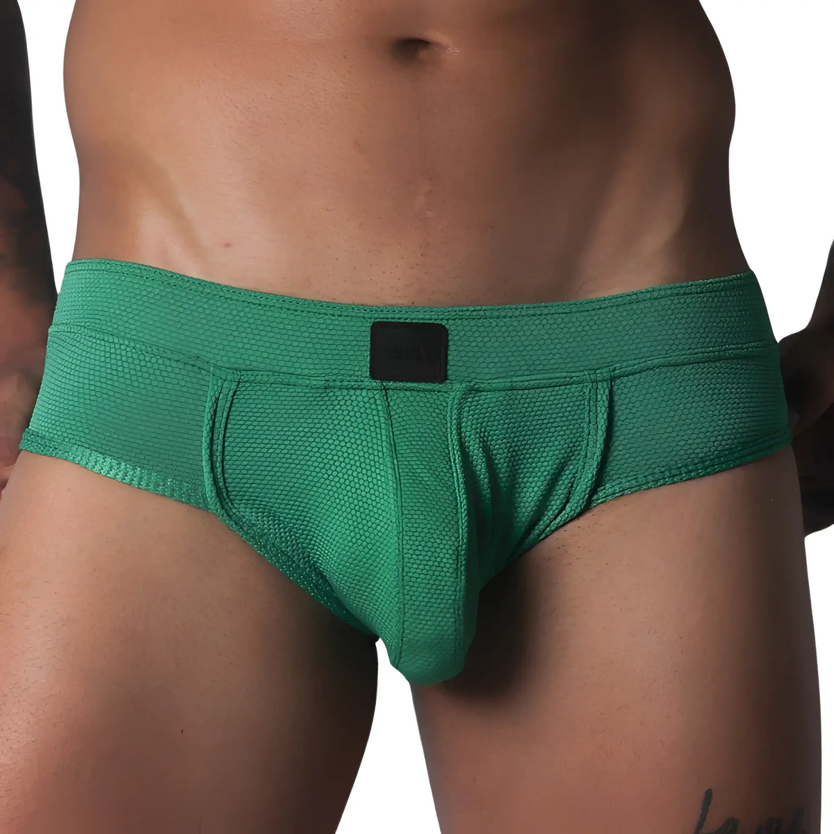 Green textured briefs with a supportive contour pouch, low-rise waistband, and small black logo patch.