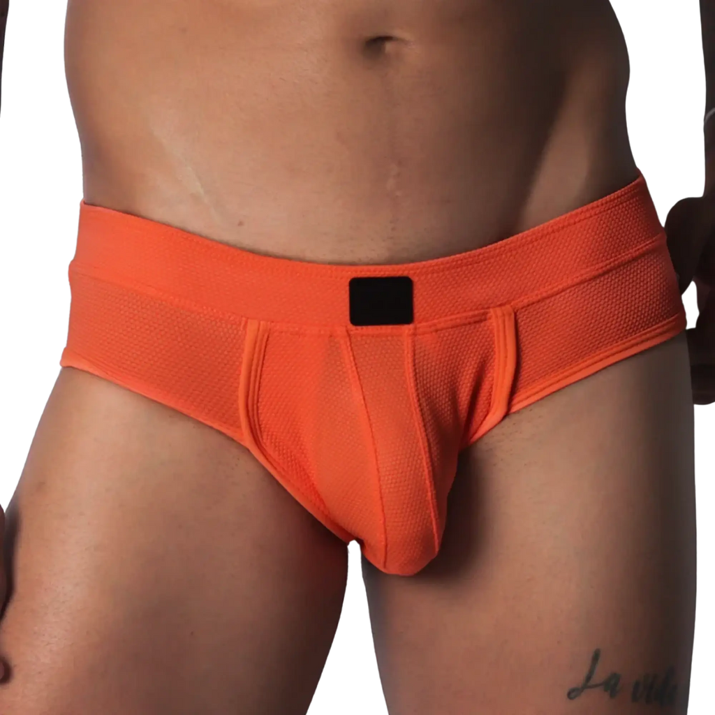 Bright orange textured micro-mesh brief with a supportive pouch and a solid black logo tag on the center waistband.