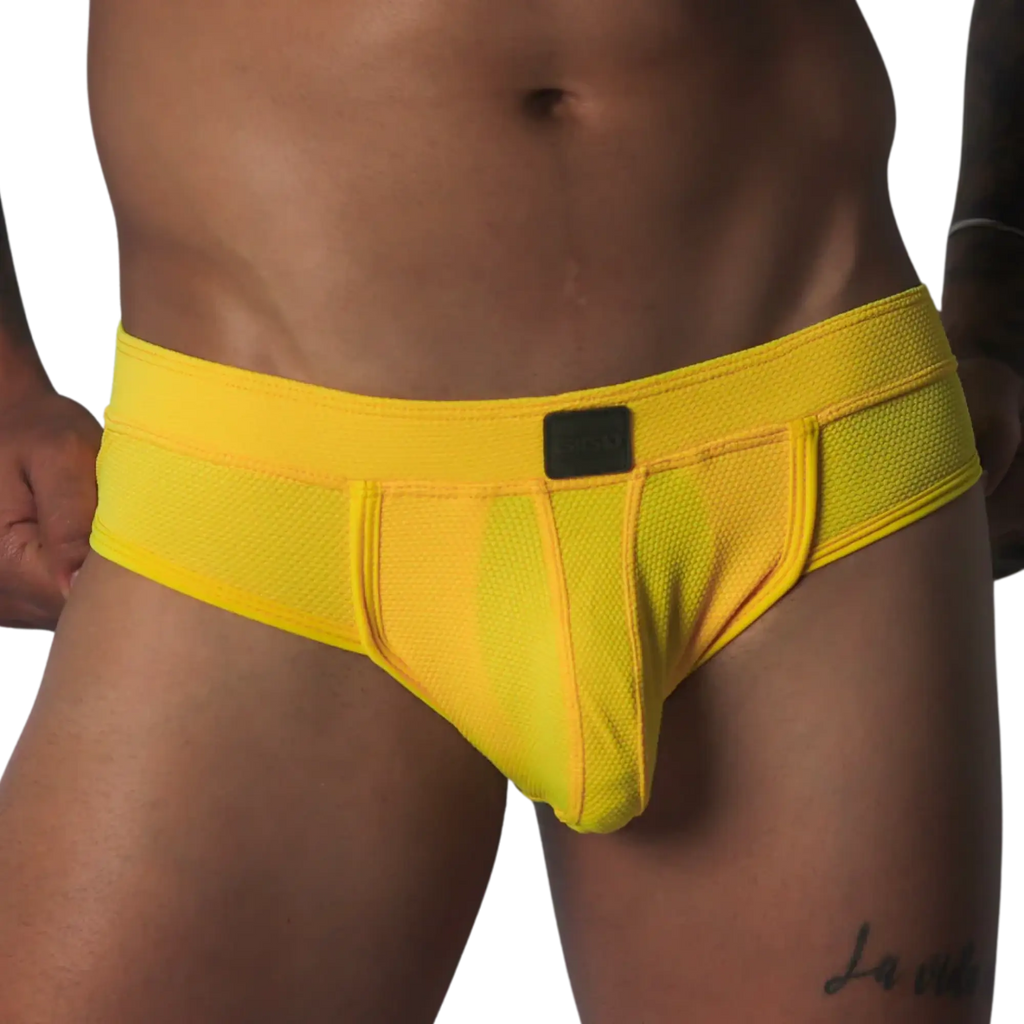 Bright yellow, textured mesh brief with a supportive pouch, tonal piping, and a small black rectangular logo patch.