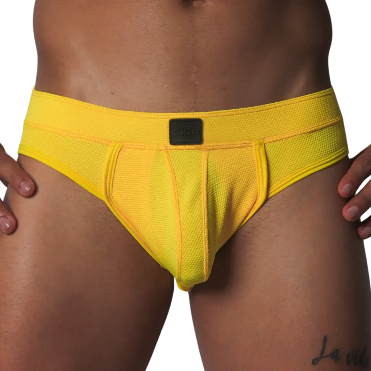 Bright yellow athletic mesh jockstrap with a wide waistband and a center black Gigo logo patch.