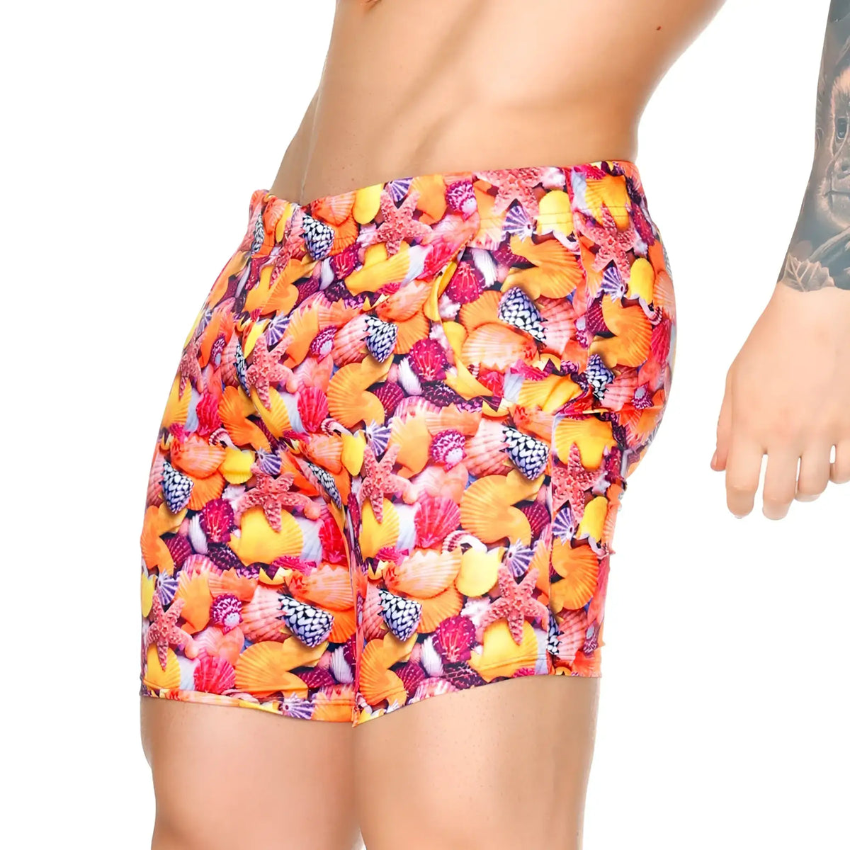 Vibrant gigo corals beachwear high-waisted swim trunks with bold seashell and starfish print in orange pink yellow and purple